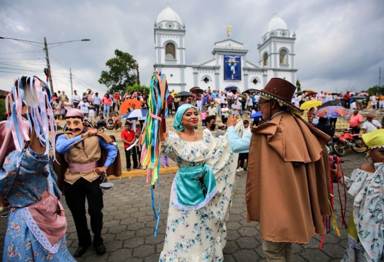 Revellers in traditional costumes dance outside a church during El Señor de Trinidad festivities in Masatepe, Nicaragua, on June 4, 2023. (Photo by STRINGER / AFP) (Photo by STRINGER/AFP via Getty Images)